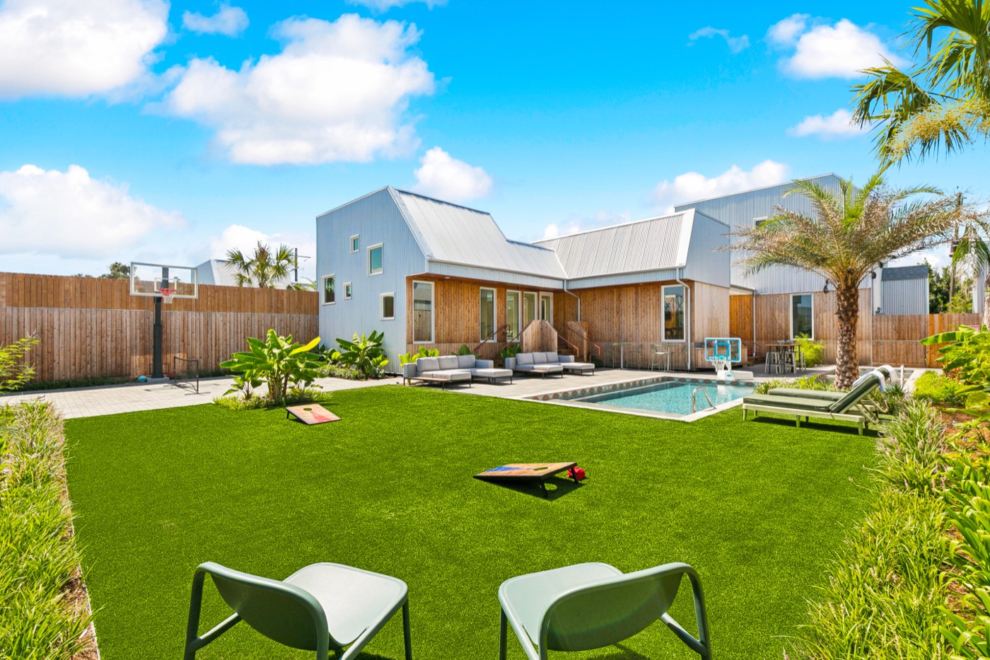 A Bywater villa compound with private pool, lawn, and basketball court